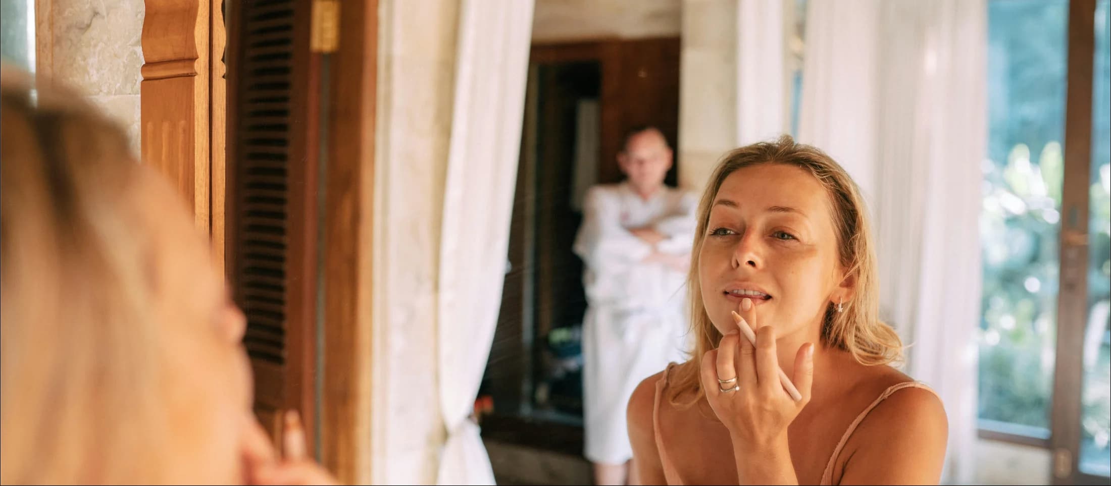 Women looking at mirror getting ready